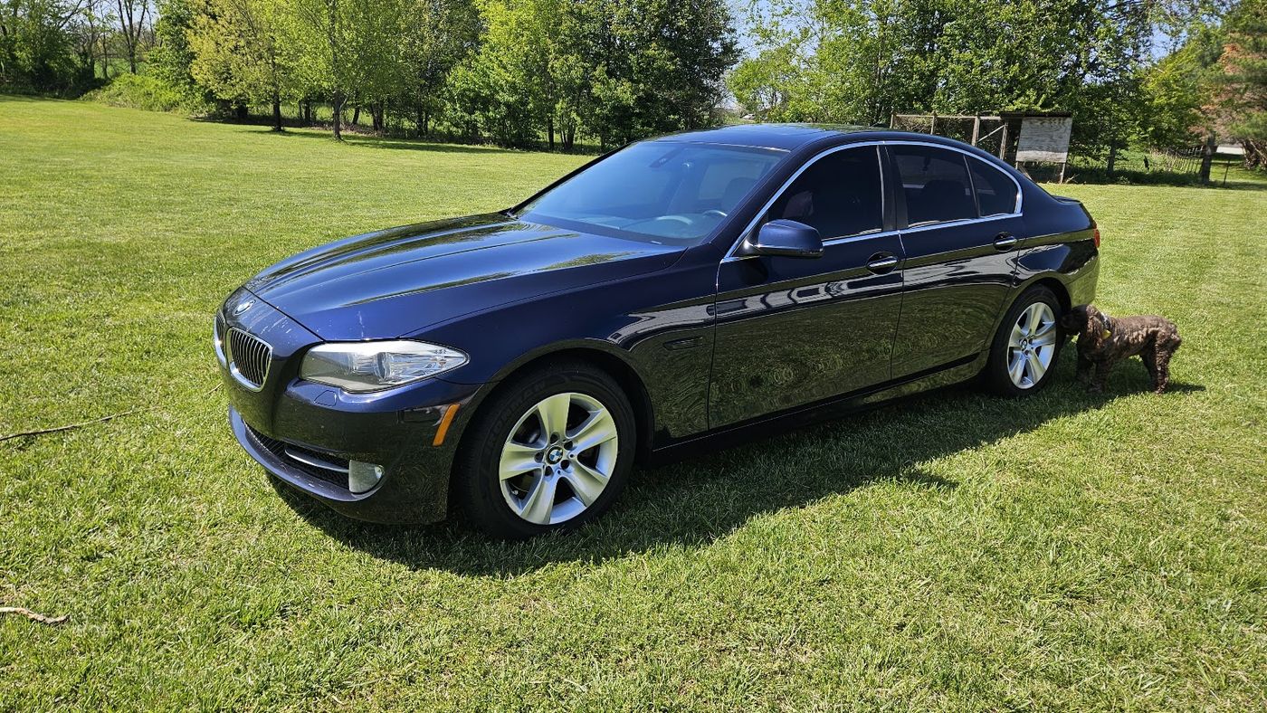 2011 BMW 528i sedan parked on the grass